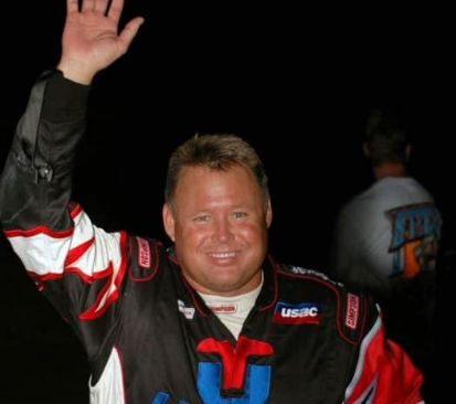 Tony Elliott in his race suit, waving to the crowd